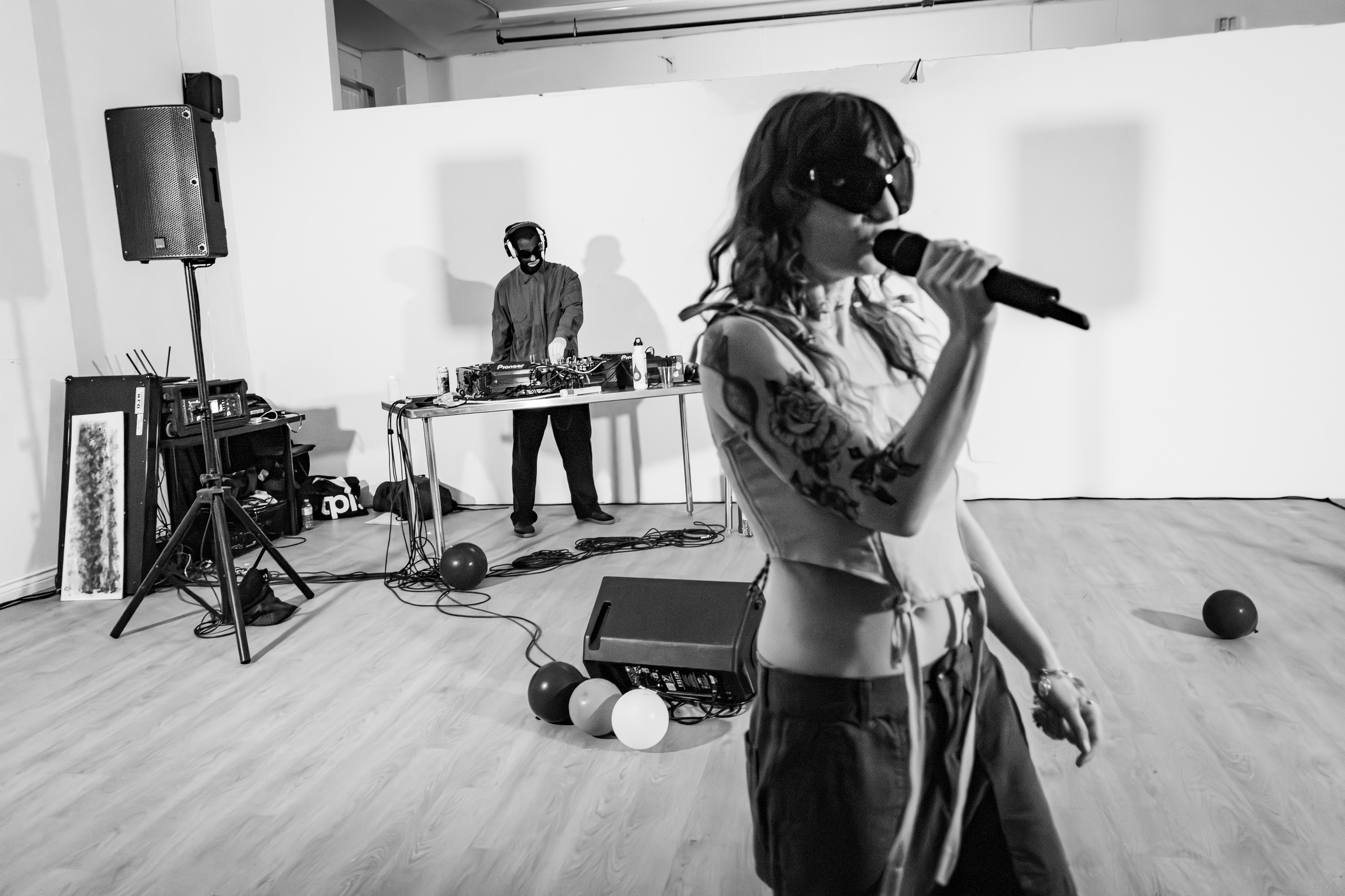 The Bugs — Nicole in foreground wearing bug sunglasses, Liam DJing in background